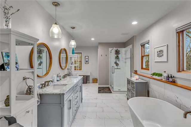 4866 Dabinawa Dr, Mclouth, KS 66054 - bathroom featuring a stall shower, a sink, a soaking tub, marble finish floor, and recessed lighting