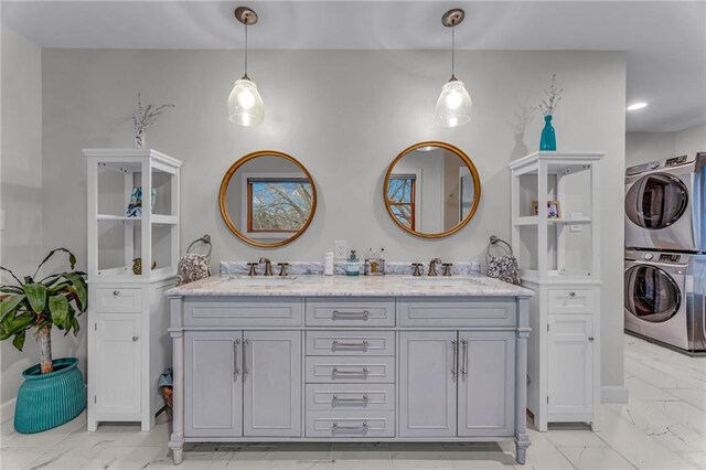 4866 Dabinawa Dr, Mclouth, KS 66054 - bathroom with marble finish floor, a sink, stacked washing maching and dryer, and double vanity