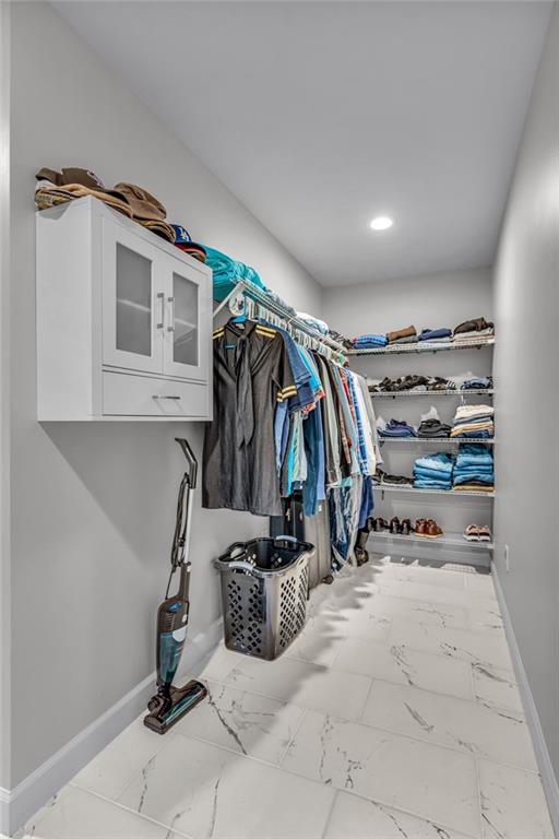 4866 Dabinawa Dr, Mclouth, KS 66054 - spacious closet featuring marble finish floor