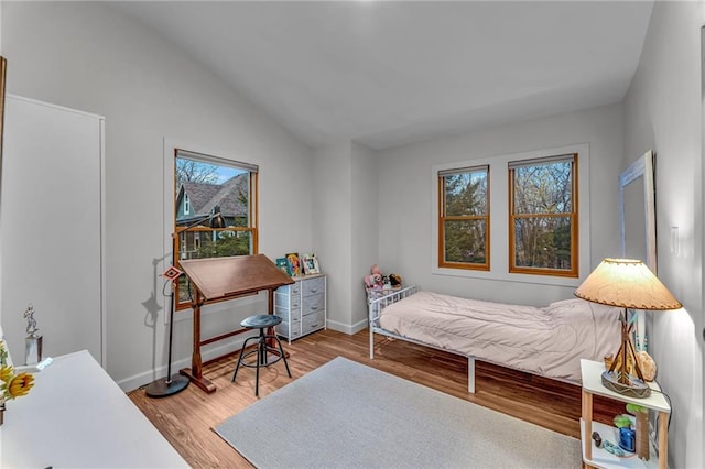 4866 Dabinawa Dr, Mclouth, KS 66054 - bedroom featuring baseboards, lofted ceiling, and light wood-style flooring