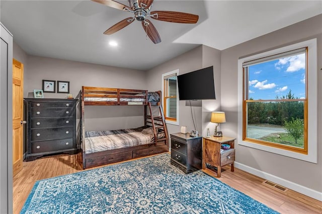 4866 Dabinawa Dr, Mclouth, KS 66054 - bedroom featuring baseboards, visible vents, wood finished floors, and a ceiling fan