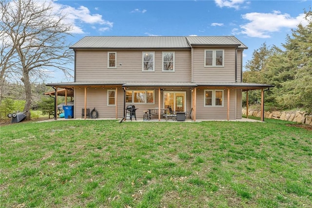 4866 Dabinawa Dr, Mclouth, KS 66054 - back of house featuring metal roof, a patio area, and a lawn