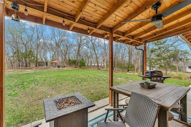 4866 Dabinawa Dr, Mclouth, KS 66054 - view of patio featuring area for grilling, an outdoor fire pit, and ceiling fan