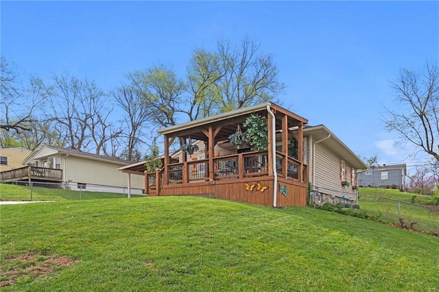 back of house featuring fence and a yard