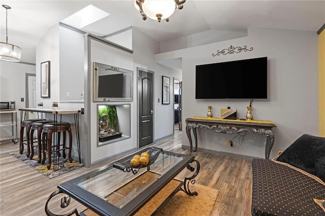 interior space with vaulted ceiling and wood finished floors