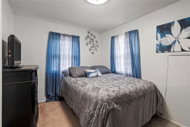 bedroom featuring light colored carpet