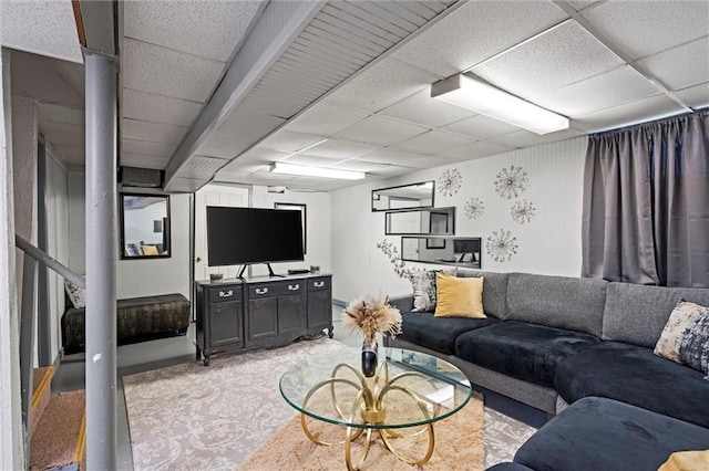 living area with light colored carpet and a paneled ceiling