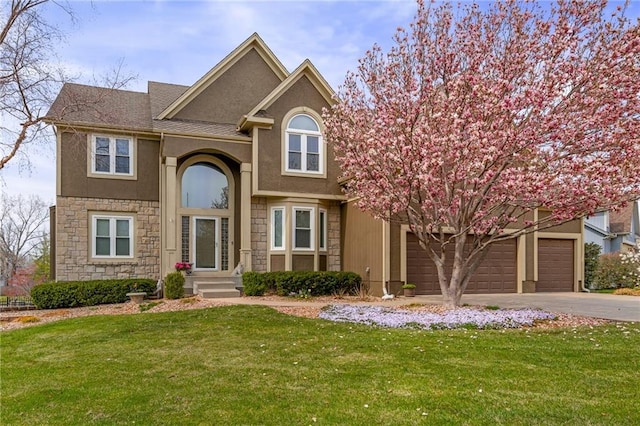 view of front of property with stone siding, asphalt driveway, a front yard, stucco siding, and an attached garage