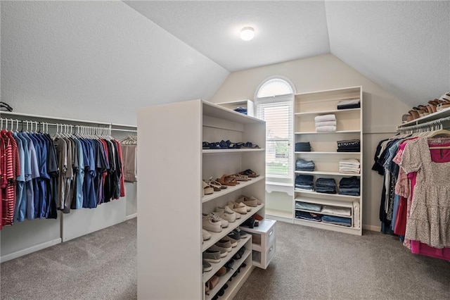 spacious closet featuring carpet flooring and lofted ceiling