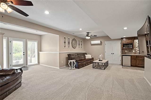 living area featuring ceiling fan, light colored carpet, baseboards, a textured ceiling, and recessed lighting