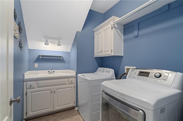 laundry area featuring cabinet space, washer and clothes dryer, and light tile patterned floors