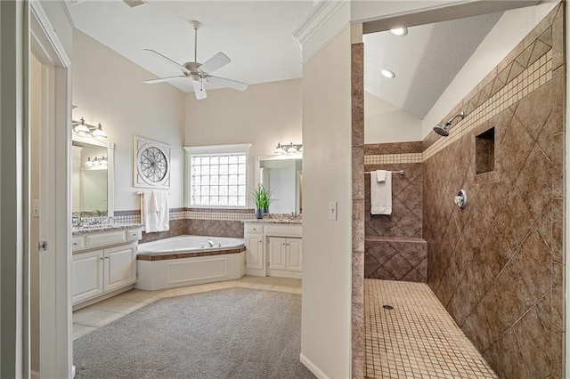 full bath featuring vaulted ceiling, a garden tub, ceiling fan, a walk in shower, and tile patterned floors