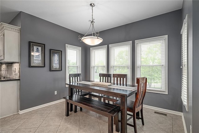 dining room with light tile patterned floors and baseboards