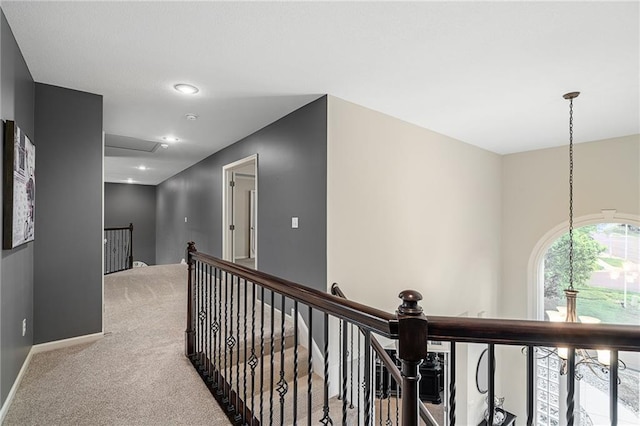 hallway featuring an upstairs landing, carpet, baseboards, and recessed lighting