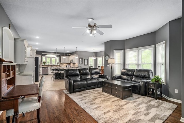 living room featuring ceiling fan, wood finished floors, baseboards, and recessed lighting