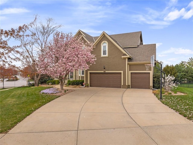 view of front of property with stucco siding, a garage, concrete driveway, and roof with shingles