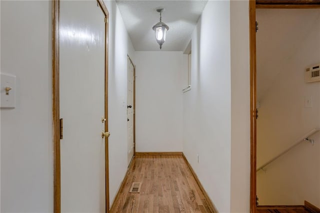 hallway featuring visible vents and light wood-style flooring