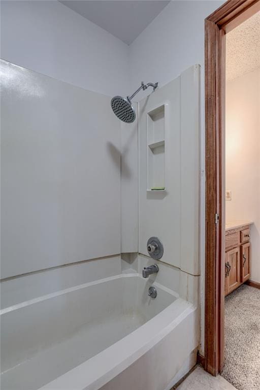 bathroom featuring vanity and  shower combination