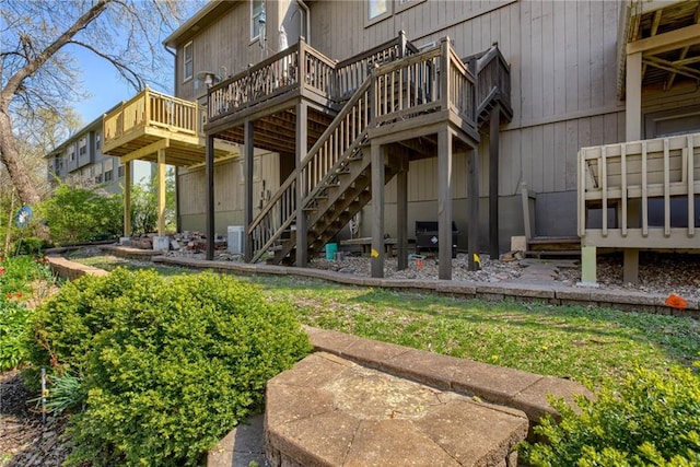 back of house with a wooden deck and stairway