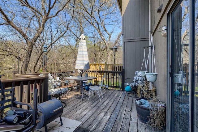wooden deck featuring outdoor dining space
