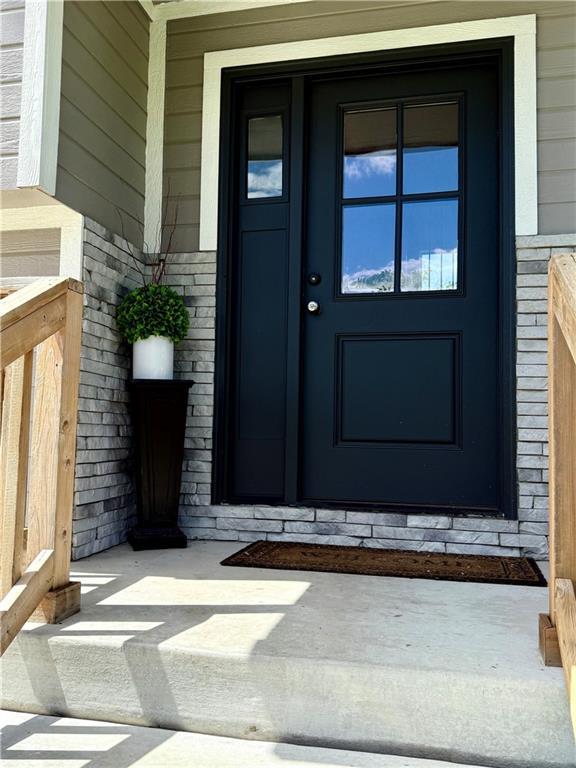 view of exterior entry featuring brick siding