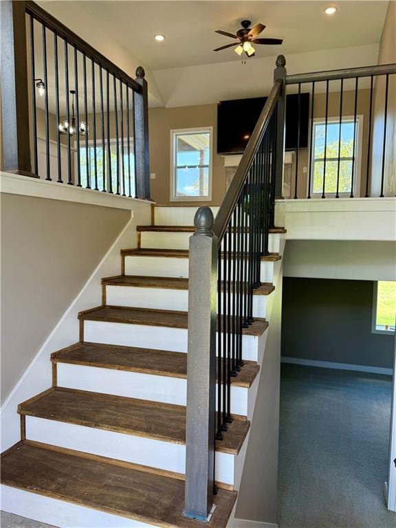 stairs featuring ceiling fan, a wealth of natural light, baseboards, and recessed lighting
