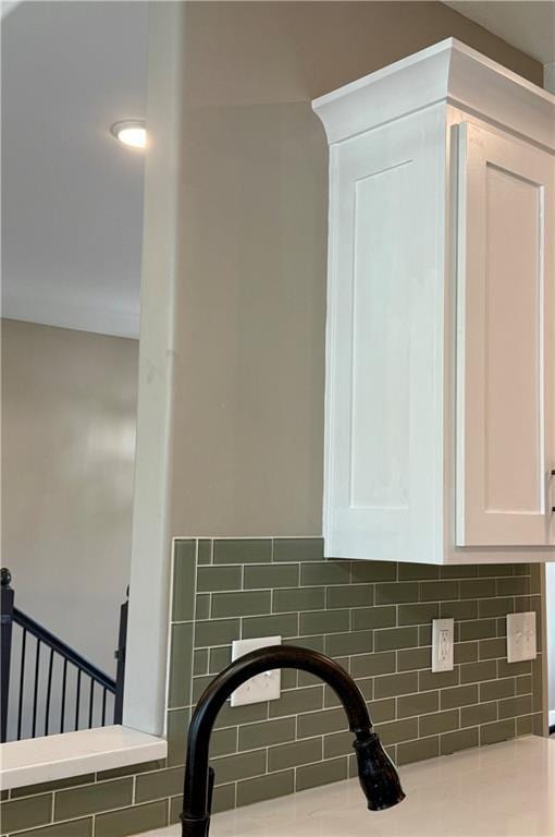 details with white cabinetry and decorative backsplash