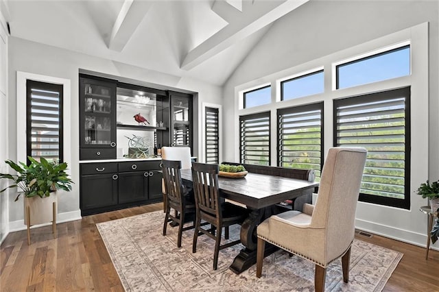 18050 N Peach Blossom Dr, Platte City, MO 64079 - dining area with dark wood-type flooring, high vaulted ceiling, and baseboards