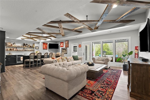 18050 N Peach Blossom Dr, Platte City, MO 64079 - living area featuring bar area, coffered ceiling, beamed ceiling, wood finished floors, and recessed lighting