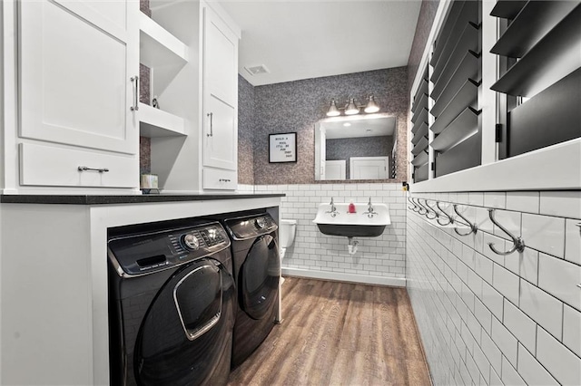 18050 N Peach Blossom Dr, Platte City, MO 64079 - laundry area with washer and dryer, tile walls, a sink, and dark wood finished floors