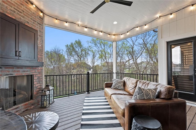 18050 N Peach Blossom Dr, Platte City, MO 64079 - sunroom / solarium with rail lighting, an outdoor living space with a fireplace, and ceiling fan