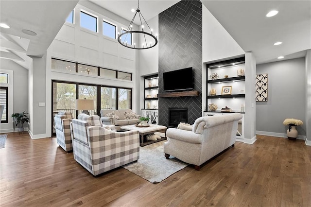 18050 N Peach Blossom Dr, Platte City, MO 64079 - living room featuring a fireplace, baseboards, dark wood-type flooring, recessed lighting, and a high ceiling