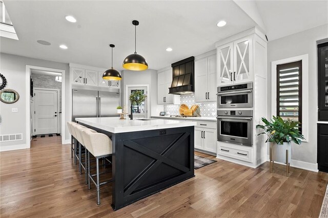 18050 N Peach Blossom Dr, Platte City, MO 64079 - kitchen with appliances with stainless steel finishes, a sink, light countertops, white cabinets, and backsplash
