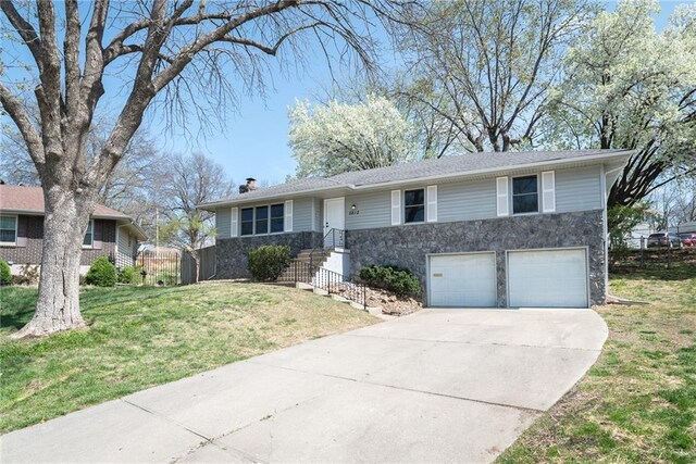 5810 E 98th Ct, Kansas City, MO 64134 - single story home featuring fence, a front lawn, concrete driveway, stone siding, and a garage