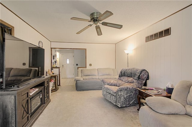 living area featuring carpet floors and a ceiling fan