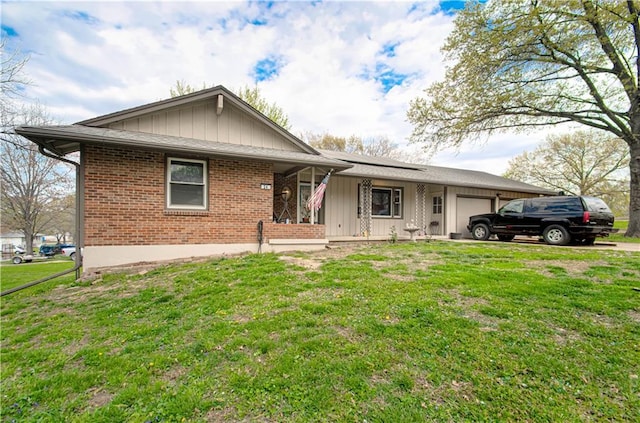 ranch-style home with a garage, board and batten siding, a porch, a front yard, and brick siding