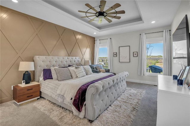 bedroom with light colored carpet, baseboards, multiple windows, and recessed lighting