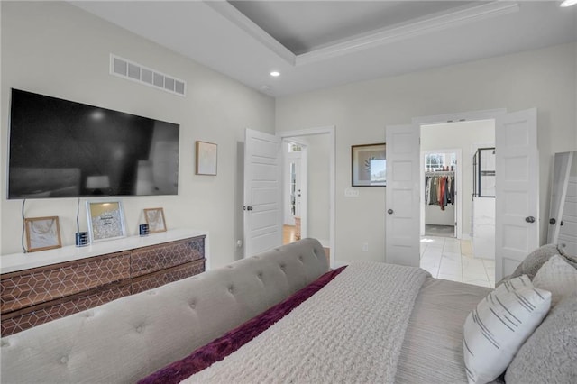 bedroom featuring a tray ceiling, visible vents, a spacious closet, recessed lighting, and marble finish floor