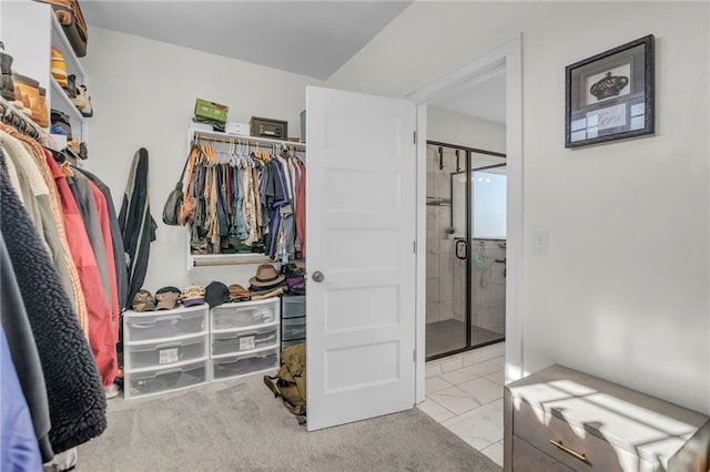 walk in closet featuring marble finish floor