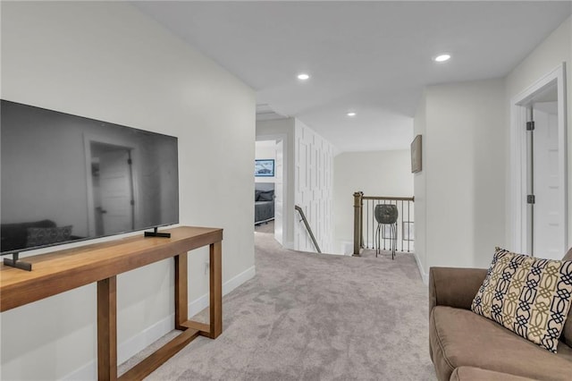 hall featuring baseboards, carpet flooring, recessed lighting, and an upstairs landing