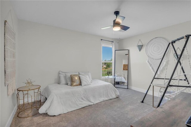 bedroom featuring ceiling fan, baseboards, and carpet flooring
