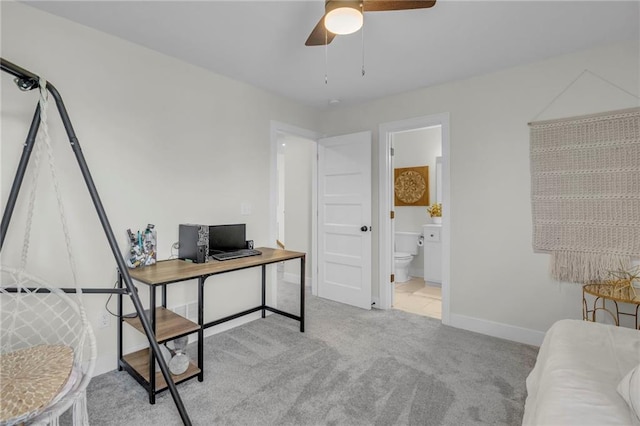 office with carpet flooring, baseboards, and a ceiling fan