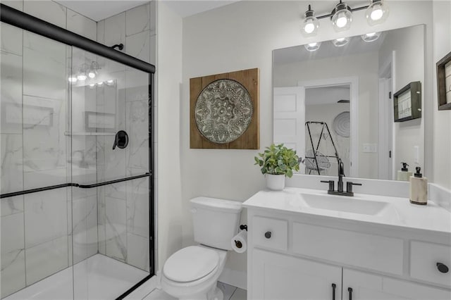 bathroom with toilet, vanity, and a stall shower