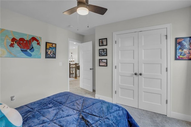 carpeted bedroom with baseboards, a ceiling fan, and a closet