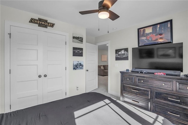 bedroom featuring a closet, carpet flooring, baseboards, and ceiling fan
