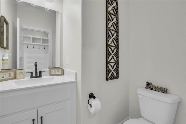 bathroom featuring toilet and vanity