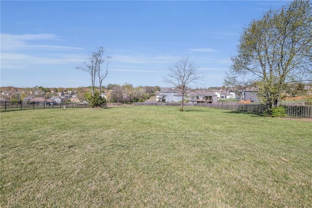 view of yard featuring a fenced backyard and a residential view