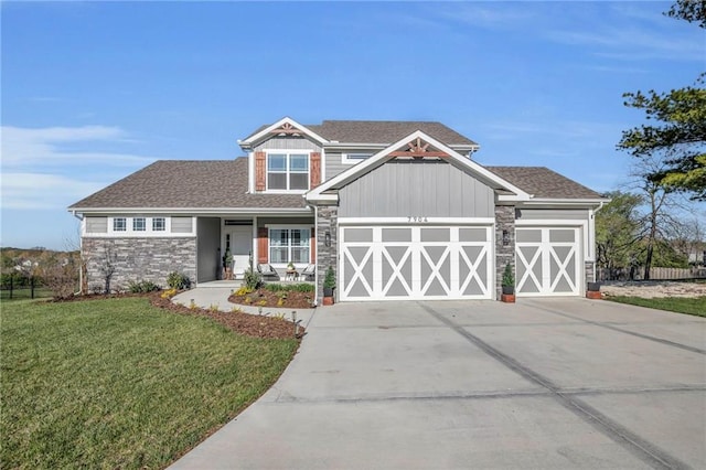 craftsman house featuring driveway, stone siding, a shingled roof, a front yard, and a garage