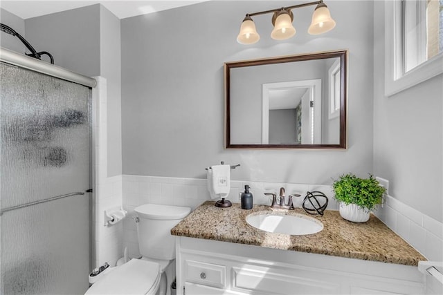 full bath featuring vanity, a stall shower, and toilet