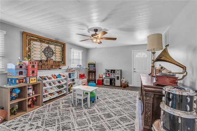 rec room with a ceiling fan and wood finished floors